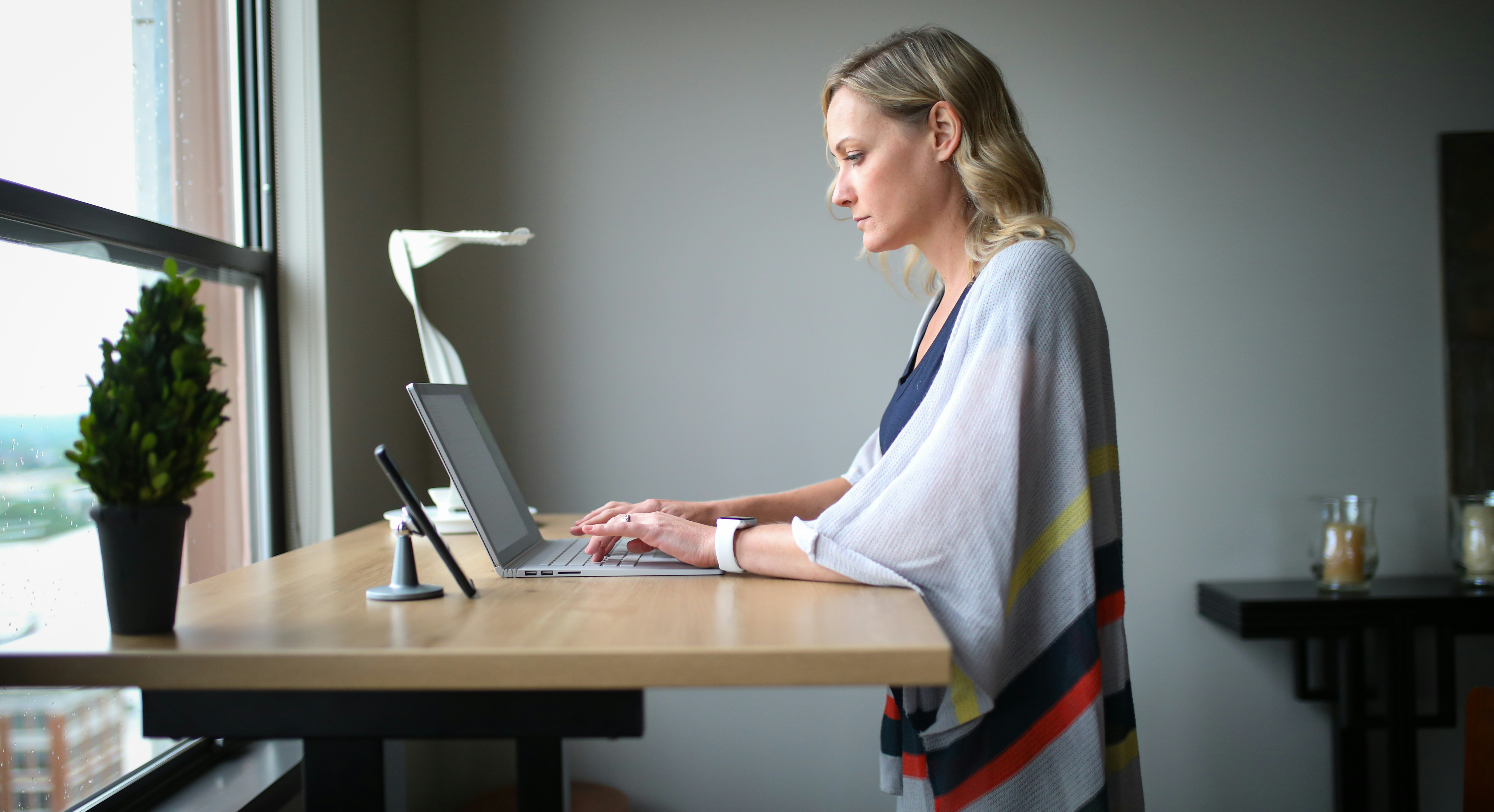 Executive working at standing desk for health optimization